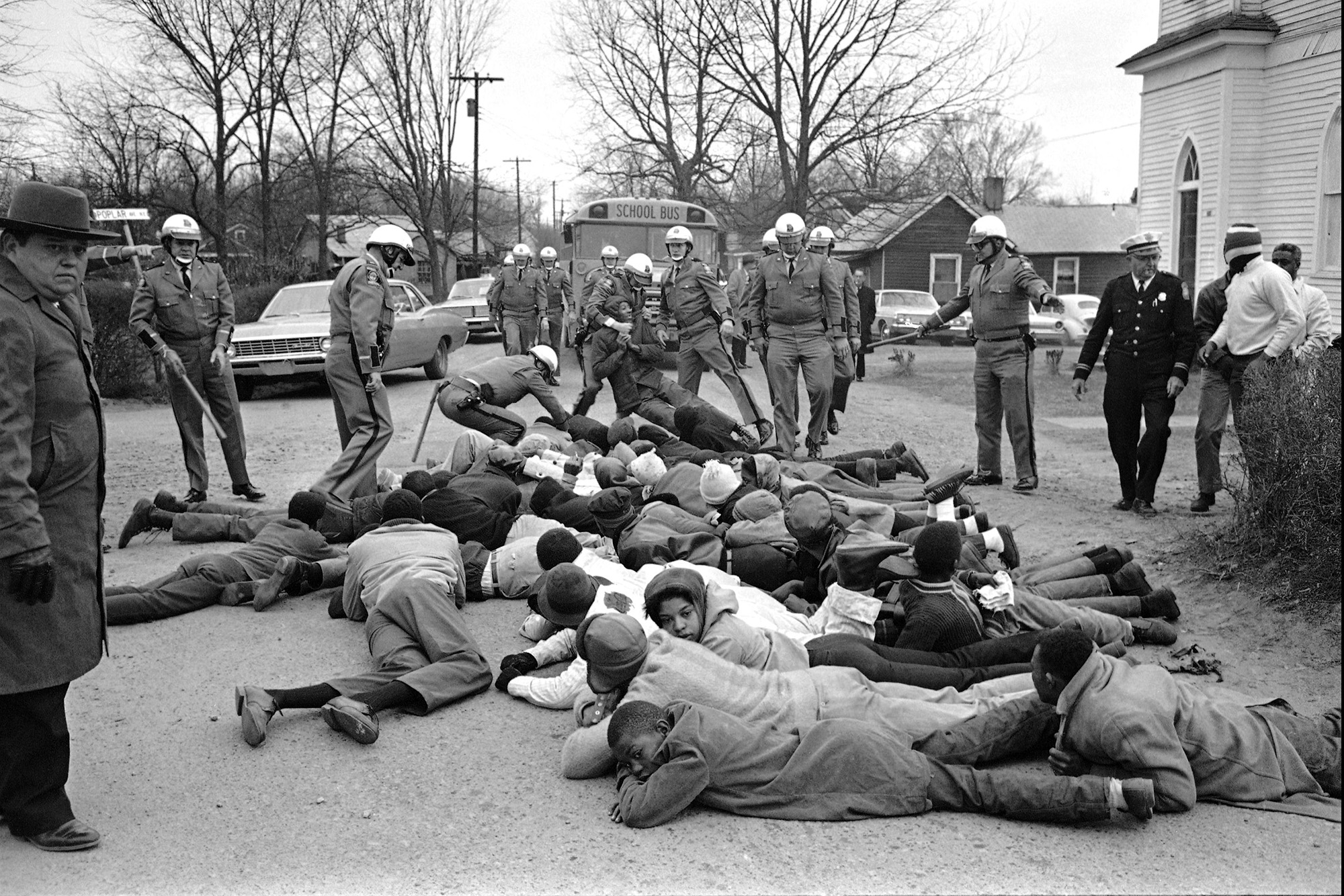 Февраль 1968-го, штат Джорджия. Военные силой удерживают группу чернокожих демонстрантов, протестовавших против плачевного состояния школ. Georgia State Troopers move in on a group of demonstrators who sprawled in front of school buses again at Social Circle, Georgia, Feb. 15, 1968. The blacks were protesting school conditions they term deplorable. About 35 demonstrators were put into a prison camp bus. It was the second day of such demonstrations. КРЕДИТ