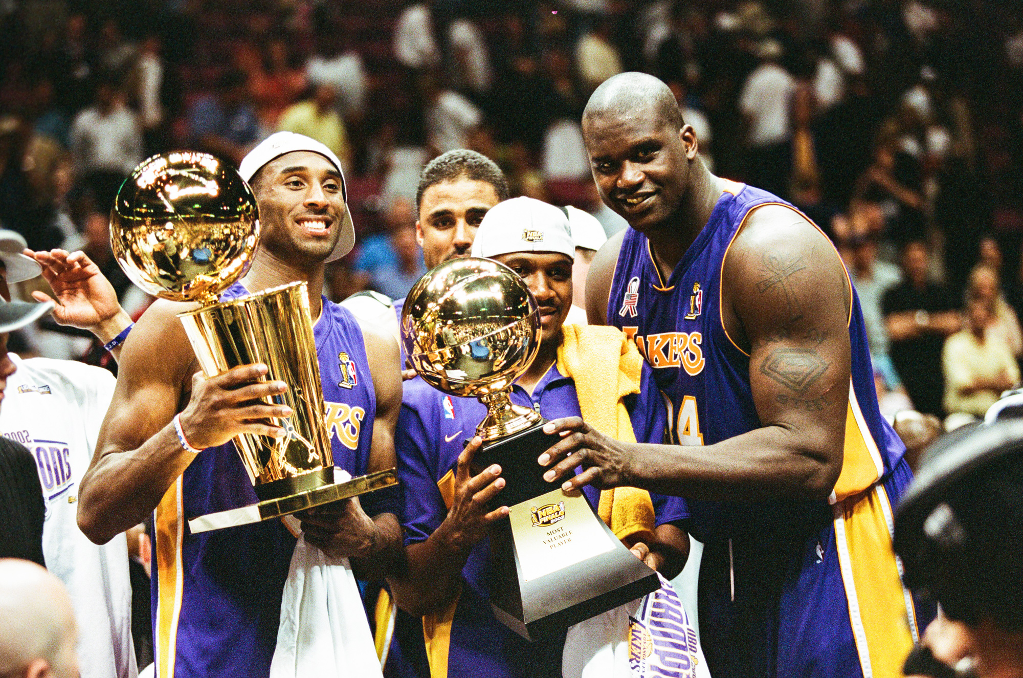 EAST RUTHERFORD, NJ - JUNE 12: Kobe Bryant, Lindsey Hunter and Shaquille O'Neal of the Los Angeles Lakers celebrate following Game Four of the NBA Finals against the New Jersey Nets on June 12, 2002 at Continental Airlines Arena in East Rutherford, New Jersey. EAST RUTHERFORD, NJ - JUNE 12: Kobe Bryant, Lindsey Hunter and Shaquille O'Neal of the Los Angeles Lakers celebrate following Game Four of the NBA Finals against the New Jersey Nets on June 12, 2002 at Continental Airlines Arena in East Rutherford, New Jersey. (Photo by Sporting News via Getty Images via Getty Images)